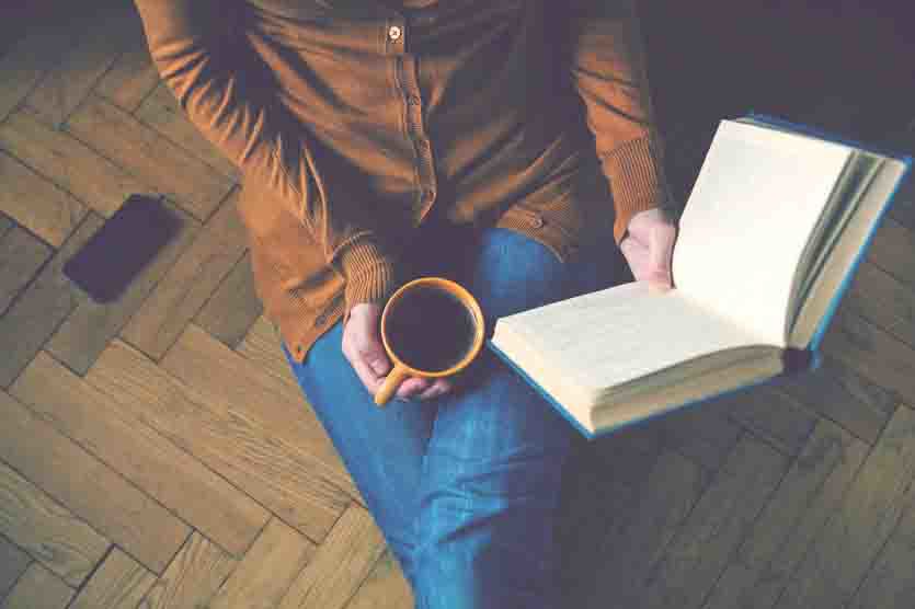 girl reading book and drinking fresh coffee